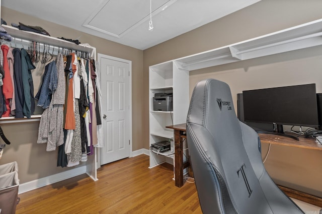 office area with baseboards and wood finished floors