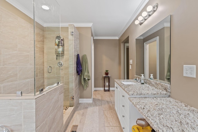 bathroom with vanity, crown molding, walk in shower, and hardwood / wood-style floors