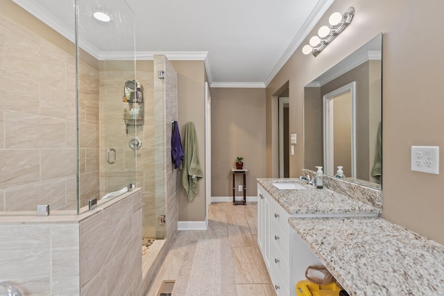 full bath featuring vanity, baseboards, crown molding, a shower stall, and visible vents