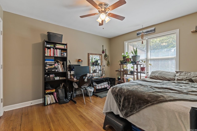 bedroom with baseboards and wood finished floors