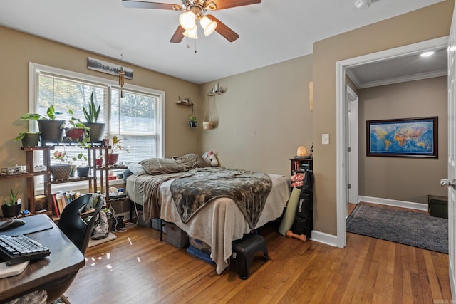 bedroom featuring baseboards, ceiling fan, and light wood-style floors