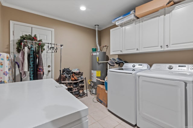 laundry area featuring washer and dryer, cabinets, ornamental molding, light tile patterned floors, and gas water heater