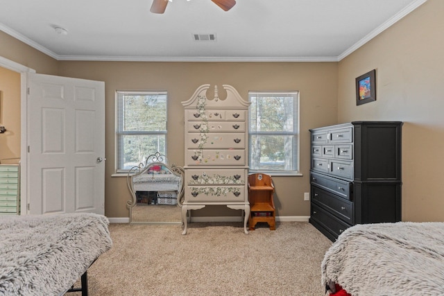 carpeted bedroom with crown molding and ceiling fan