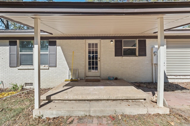 property entrance with brick siding