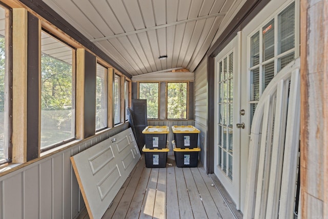 unfurnished sunroom featuring lofted ceiling, wood ceiling, and plenty of natural light