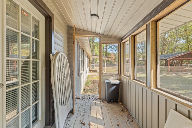 unfurnished sunroom featuring lofted ceiling and wood ceiling