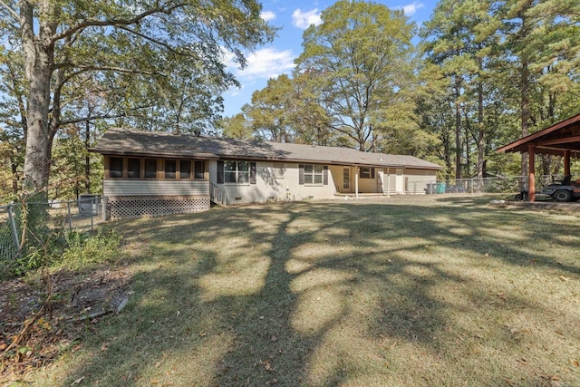 back of property with fence and a lawn