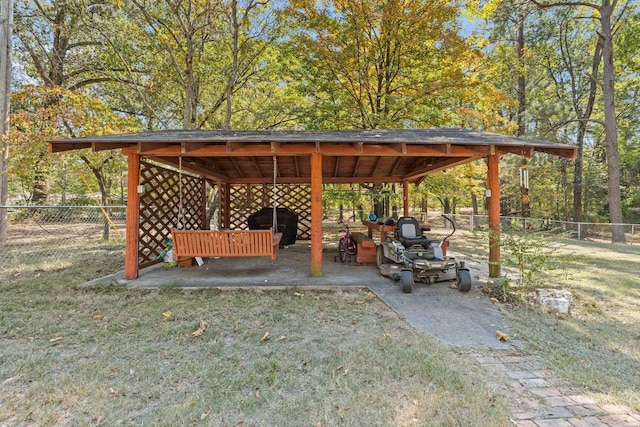 view of property's community with a carport, fence, and a lawn