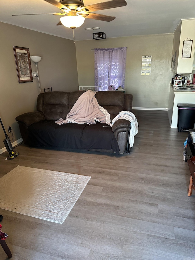 living room featuring light hardwood / wood-style floors and ceiling fan