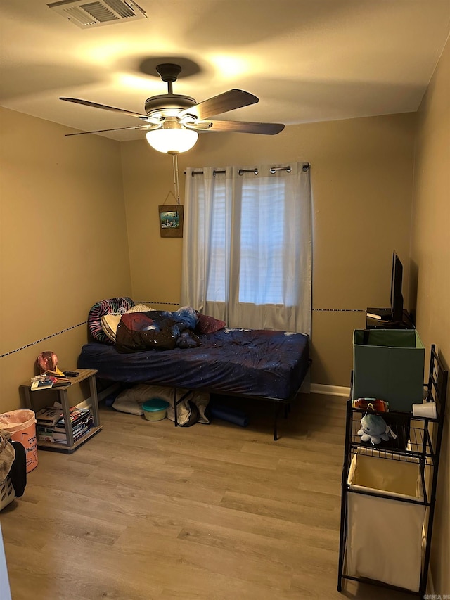 bedroom featuring ceiling fan and light hardwood / wood-style flooring