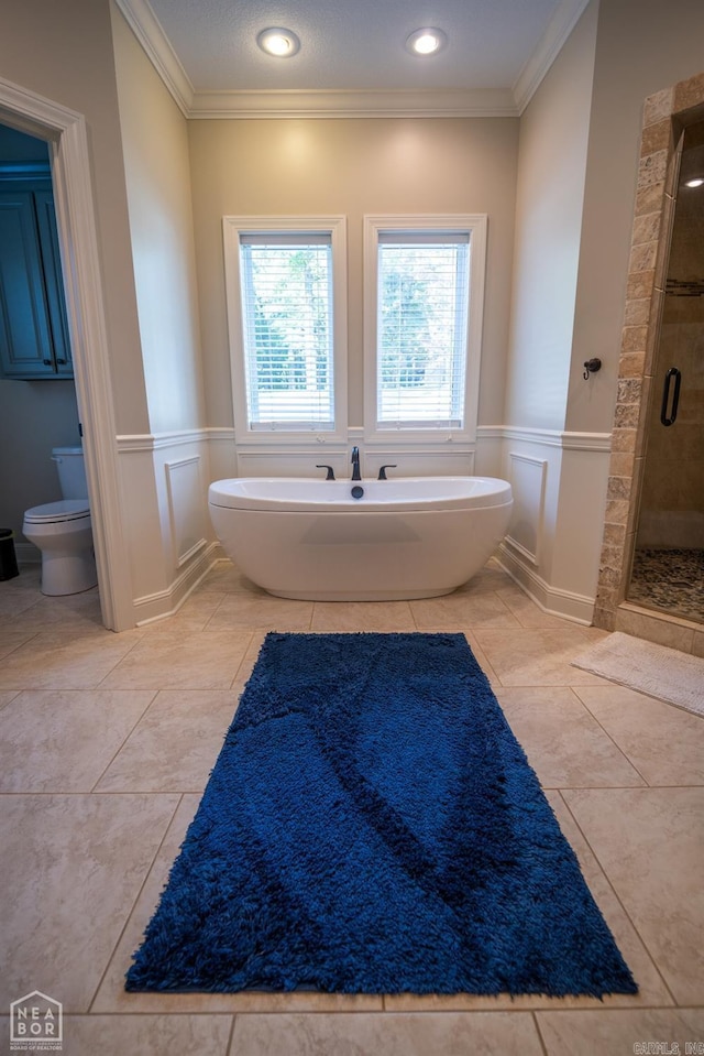 bathroom featuring tile patterned floors, plus walk in shower, ornamental molding, and toilet