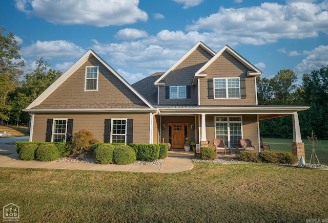 craftsman inspired home with a porch and a front lawn