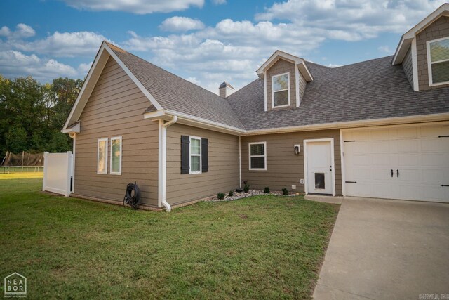 view of front facade with a front lawn and a garage