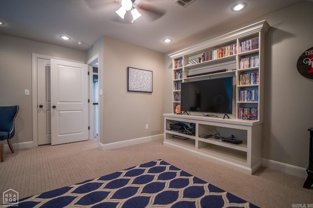 living area with carpet floors and ceiling fan