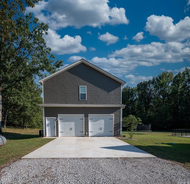 view of property exterior featuring central air condition unit, a trampoline, a garage, and a lawn