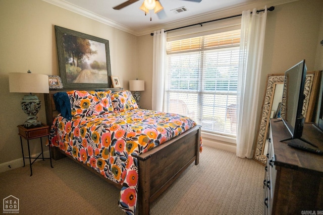 carpeted bedroom with ceiling fan, ornamental molding, and multiple windows