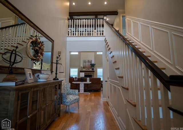 foyer featuring a towering ceiling and light hardwood / wood-style floors