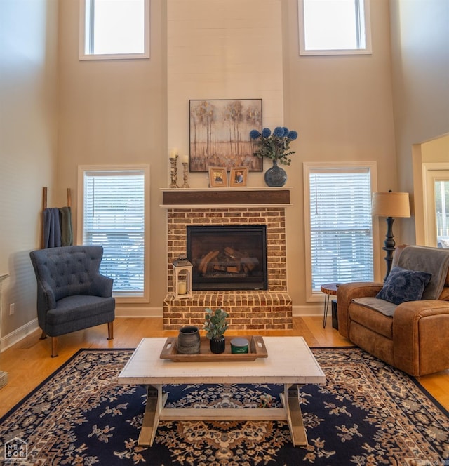 living room featuring a healthy amount of sunlight and a towering ceiling