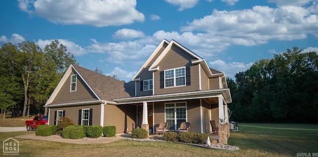 craftsman-style house with a porch and a front lawn