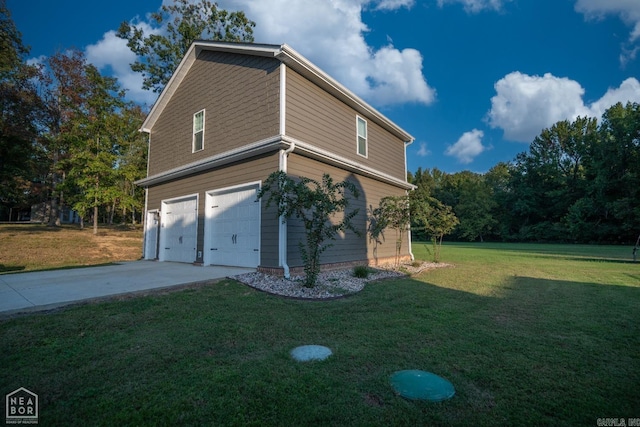 view of home's exterior with a yard and a garage