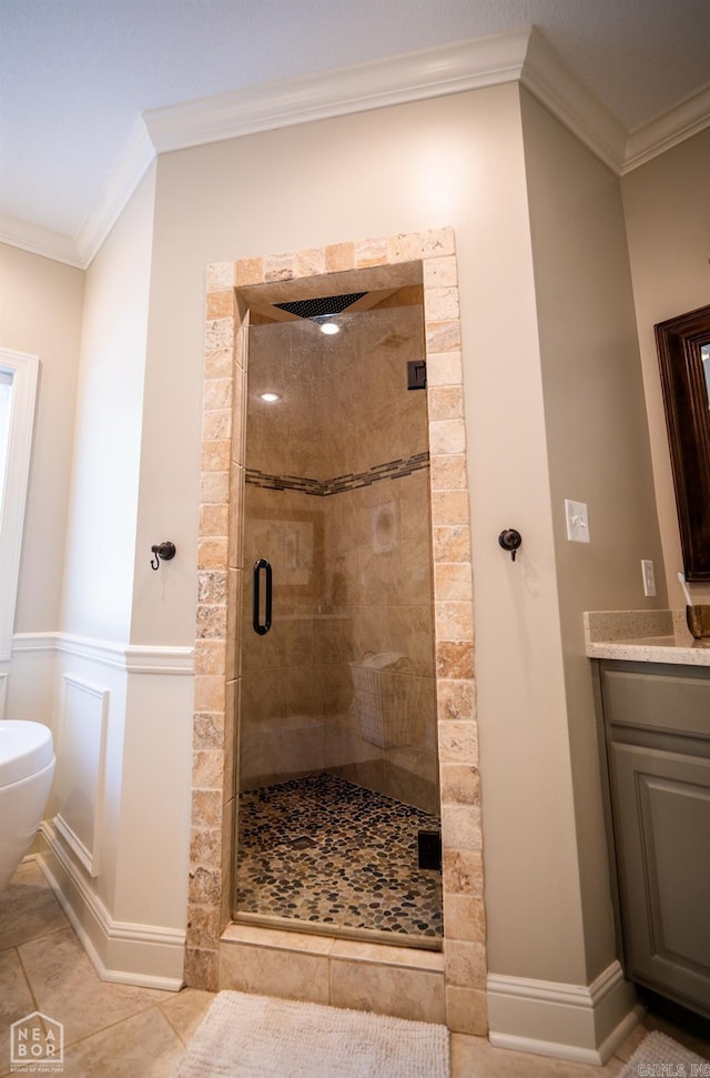 bathroom with vanity, crown molding, a shower with shower door, and toilet