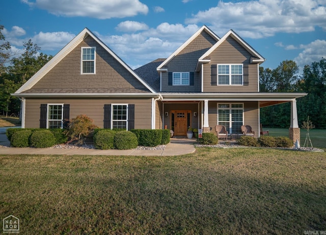 craftsman inspired home featuring a front yard and covered porch