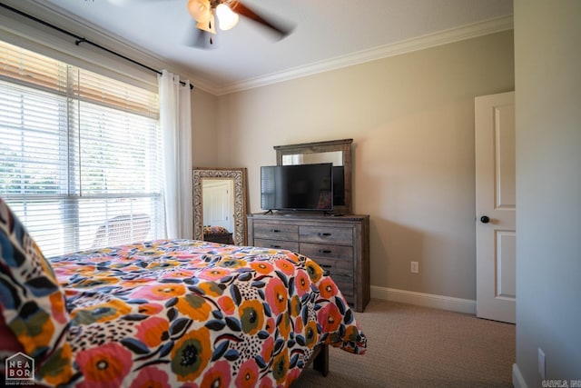 carpeted bedroom with ceiling fan and crown molding