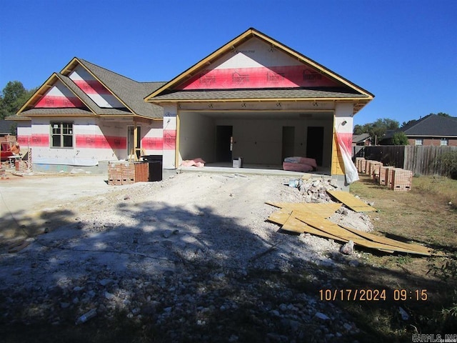 view of front of house featuring a garage, fence, and a patio