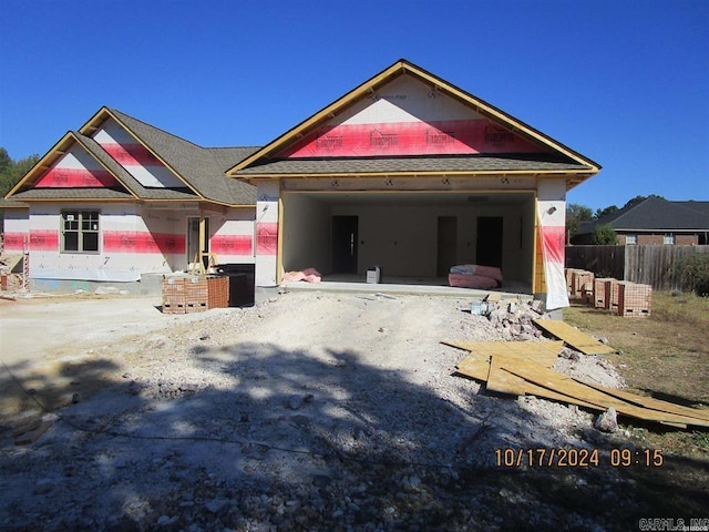 view of front of home with a garage, a patio area, and fence