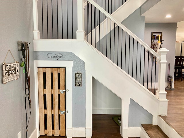 stairs featuring hardwood / wood-style flooring