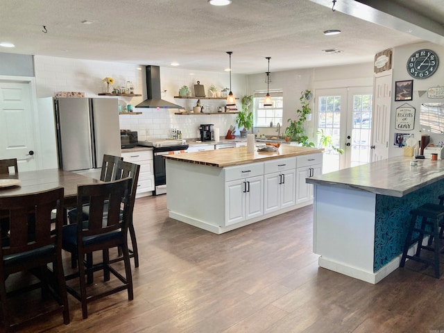 kitchen featuring white cabinets, range with electric cooktop, dark hardwood / wood-style floors, and island range hood