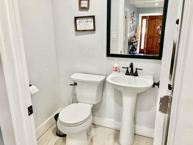183 Sunny Gap Rd, Conway, AR 72032 - half bathroom featuring toilet, baseboards, and a sink
