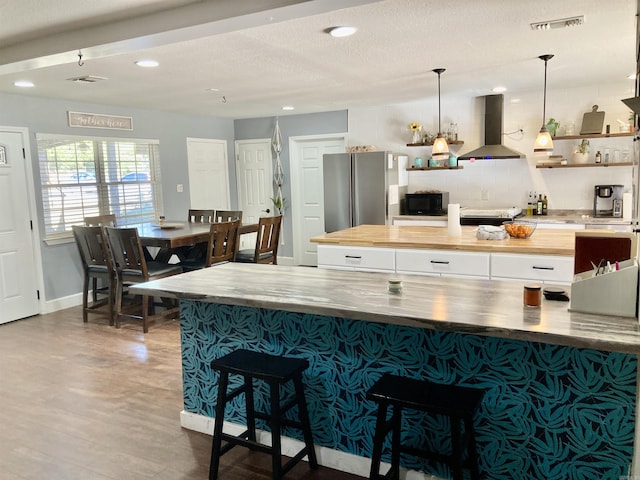 183 Sunny Gap Rd, Conway, AR 72032 - kitchen with exhaust hood, wooden counters, freestanding refrigerator, a spacious island, and recessed lighting