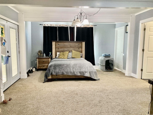 bedroom with an inviting chandelier, french doors, and carpet flooring