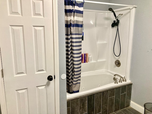 bathroom with tile patterned flooring and shower / tub combo