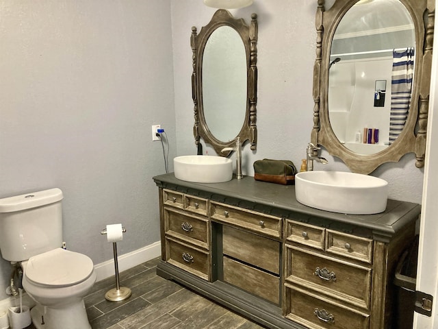 183 Sunny Gap Rd, Conway, AR 72032 - full bath with baseboards, double vanity, toilet, wood tiled floors, and a shower with shower curtain