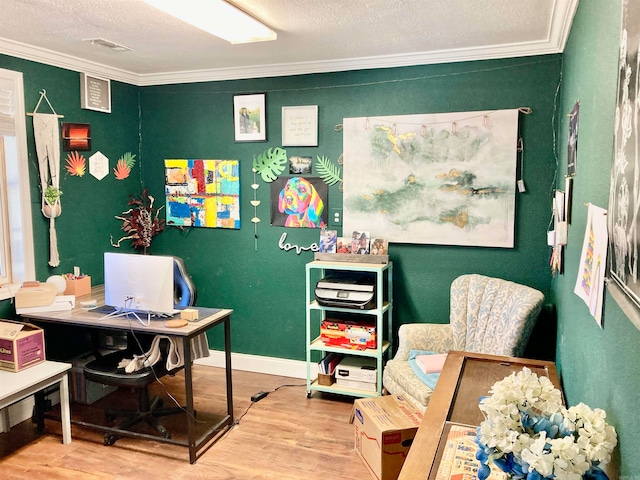 office area with crown molding, wood-type flooring, and a textured ceiling