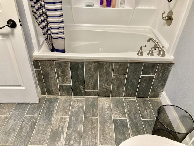 183 Sunny Gap Rd, Conway, AR 72032 - full bathroom featuring a combined bath / shower with jetted tub, wood finished floors, and toilet