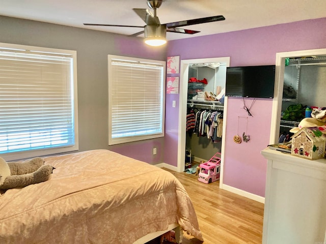 bedroom with hardwood / wood-style floors, a closet, and ceiling fan