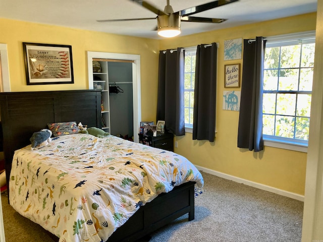 carpeted bedroom with multiple windows, a closet, and ceiling fan