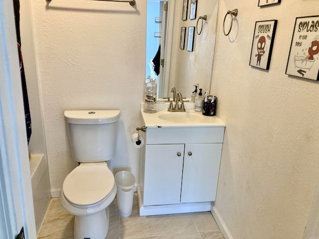 bathroom with a tub to relax in, vanity, toilet, and tile patterned flooring