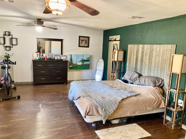 bedroom with ceiling fan and dark hardwood / wood-style flooring