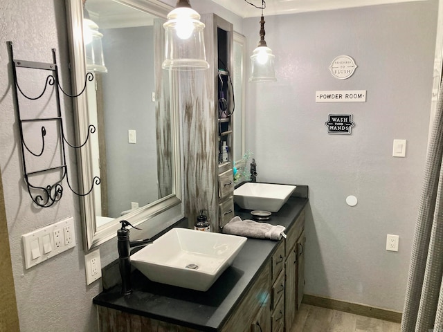 bathroom featuring vanity, hardwood / wood-style floors, and ornamental molding