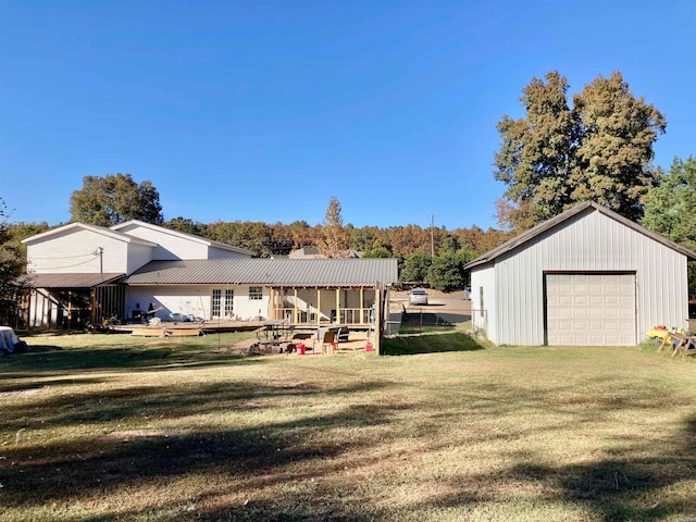 exterior space featuring an outdoor structure, a garage, and a lawn