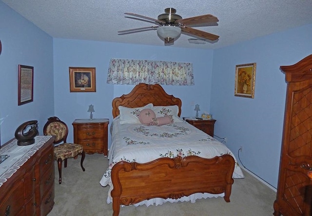 carpeted bedroom with a textured ceiling and ceiling fan