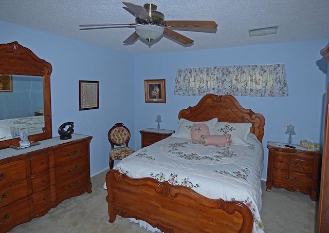 bedroom with light carpet, a textured ceiling, and ceiling fan