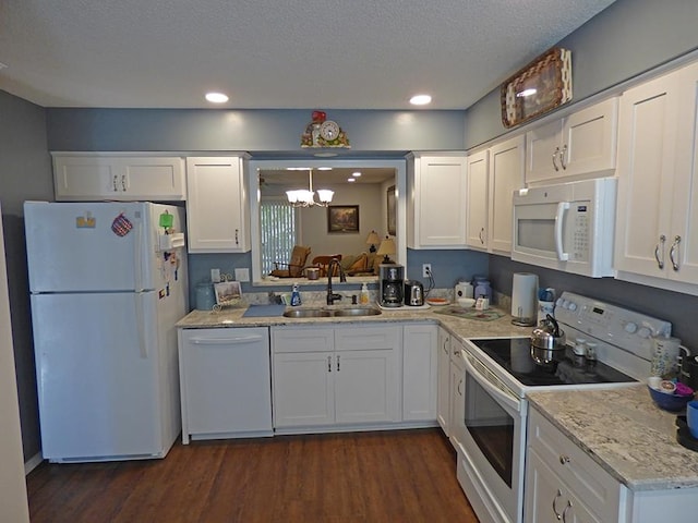 kitchen featuring white cabinetry and white appliances