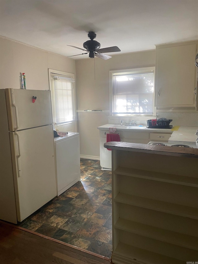 kitchen with dark hardwood / wood-style flooring, white fridge, ceiling fan, and a wealth of natural light