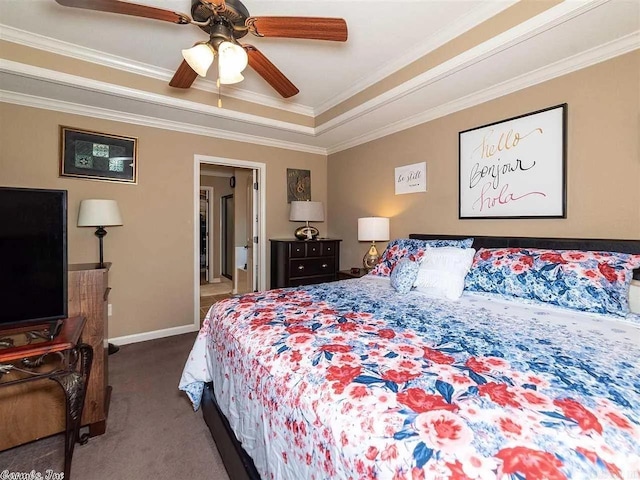 carpeted bedroom with ceiling fan, a raised ceiling, and crown molding