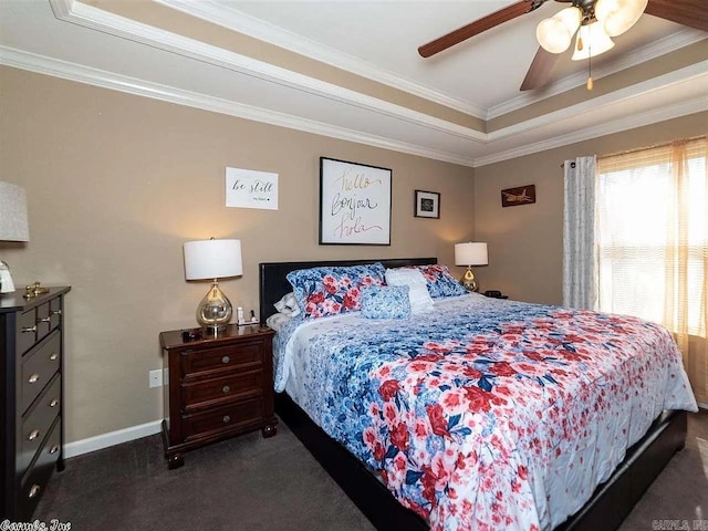 bedroom with dark carpet, a raised ceiling, ceiling fan, and ornamental molding